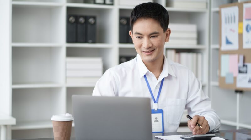 Young Asian businessman use digital calculator for tax, salary and personal expenses.